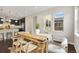 Inviting dining area features hardwood floors and a farmhouse table with modern chairs and natural light at 15980 Pikes Peak Dr, Broomfield, CO 80023