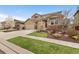 Charming two-story home with a three-car garage, stone accents and well-manicured front yard at 15980 Pikes Peak Dr, Broomfield, CO 80023