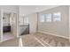 Upstairs hallway that features neutral carpeting and a bright bathroom with a dark cabinet vanity at 15980 Pikes Peak Dr, Broomfield, CO 80023