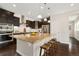 Well-lit kitchen featuring a large island with granite countertops, barstool seating, and stainless appliances at 15980 Pikes Peak Dr, Broomfield, CO 80023