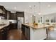 Spacious kitchen with stainless steel appliances, granite countertops, dark cabinets, and view to dining area at 15980 Pikes Peak Dr, Broomfield, CO 80023
