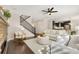 Open-concept living room features hardwood floors, a fireplace, and staircase to the upper level at 15980 Pikes Peak Dr, Broomfield, CO 80023