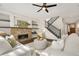 Inviting living room with a fireplace, built-in shelves, stylish furniture, and hardwood floors at 15980 Pikes Peak Dr, Broomfield, CO 80023