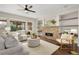 Bright living room with stone fireplace, stylish furniture, and hardwood floors at 15980 Pikes Peak Dr, Broomfield, CO 80023
