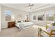 Spacious main bedroom featuring a tray ceiling, ample natural light, and a cozy seating area for relaxation at 15980 Pikes Peak Dr, Broomfield, CO 80023