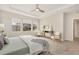 Serene main bedroom featuring a tray ceiling, comfortable seating, and soft natural light for a relaxing retreat at 15980 Pikes Peak Dr, Broomfield, CO 80023