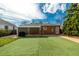 Backyard featuring an artificial turf lawn, covered patio, and brick house with a blue sky at 1386 S Garfield St, Denver, CO 80210