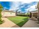 A well-maintained backyard featuring artificial turf and a covered patio for outdoor relaxation and entertainment at 1386 S Garfield St, Denver, CO 80210