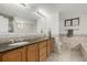 Bathroom featuring a double vanity sink, shower, and tiled backsplash at 1386 S Garfield St, Denver, CO 80210