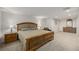This spacious bedroom features neutral carpet, a queen sized bed, nightstands, and a dresser with a mirror at 1386 S Garfield St, Denver, CO 80210