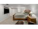 This bedroom has carpet and a TV, as well as a queen-sized bed and a lamp on a nightstand at 1386 S Garfield St, Denver, CO 80210
