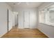 A cozy bedroom features hardwood floors, natural light from a window, and white painted walls at 1386 S Garfield St, Denver, CO 80210