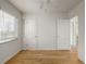 A spacious bedroom features hardwood floors, a built-in bookshelf, and a double door closet at 1386 S Garfield St, Denver, CO 80210