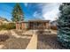 Quaint brick house showcasing a cozy covered porch and a mature shade tree at 1386 S Garfield St, Denver, CO 80210