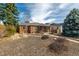 All brick home with covered porch and natural rock and mulch landscaping at 1386 S Garfield St, Denver, CO 80210