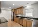 Modern kitchen with stainless steel appliances, granite countertops, and wood cabinets at 1386 S Garfield St, Denver, CO 80210