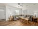 Bright living room with hardwood floors, ceiling fan, and a neutral-toned sectional sofa at 1386 S Garfield St, Denver, CO 80210