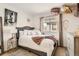 Bright bedroom featuring a stylish bed frame, cozy linens, and an abundance of natural light at 2116 W 101St Cir, Thornton, CO 80260