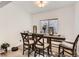 Dining room with modern table, seating for six, and large window at 2116 W 101St Cir, Thornton, CO 80260