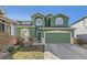 Charming green two-story home with a two-car garage and well-maintained front yard at 2116 W 101St Cir, Thornton, CO 80260
