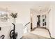 Bright hallway with natural light, showcasing a stylish chandelier and access to various rooms at 2116 W 101St Cir, Thornton, CO 80260