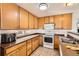 Functional kitchen with wood cabinets, standard appliances, and lots of counter space at 2116 W 101St Cir, Thornton, CO 80260