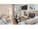 Cozy living room with hardwood floors, fireplace, and natural light from the window at 2116 W 101St Cir, Thornton, CO 80260