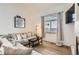 Inviting living room featuring a large sofa, hardwood floors, and natural light at 2116 W 101St Cir, Thornton, CO 80260