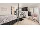 Spacious main bedroom with a four poster bed, mounted television and lots of natural light at 2116 W 101St Cir, Thornton, CO 80260