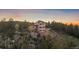 Majestic aerial view of mountain home nestled in a serene forest setting at dusk. Gorgeous landscaping! at 23007 Big Game Trl, Conifer, CO 80433