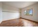 Neutral bedroom with hardwood flooring and natural light; an ideal space for personalization and relaxation at 23007 Big Game Trl, Conifer, CO 80433