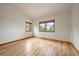 Cozy bedroom with hardwood floors and natural light, with views of nature outside the windows at 23007 Big Game Trl, Conifer, CO 80433