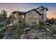 A stunning mountain home showcasing stone accents and a welcoming entrance, surrounded by nature's beauty at 23007 Big Game Trl, Conifer, CO 80433