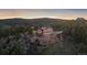 Beautiful home with large windows, a built-in outdoor grill, and terraced landscaping on a hilltop at 23007 Big Game Trl, Conifer, CO 80433