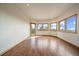 Bright and airy living room featuring hardwood floors, scenic mountain views from the large windows, and an outdoor access at 23007 Big Game Trl, Conifer, CO 80433