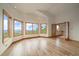 Spacious living room featuring a vaulted ceiling, wood floors, and large windows with mountain views at 23007 Big Game Trl, Conifer, CO 80433