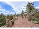 Outdoor stone patio with an outdoor grill, built-in seating, and panoramic views of the mountains at 23007 Big Game Trl, Conifer, CO 80433