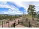 Scenic outdoor patio with stone path and built in fireplace perfect for gatherings with panoramic mountain views at 23007 Big Game Trl, Conifer, CO 80433