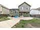Backyard featuring a large concrete patio, grassy area, and a fenced perimeter at 6358 E 121St Pl, Brighton, CO 80602
