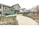 Landscaped backyard featuring a concrete patio and a green house at 6358 E 121St Pl, Brighton, CO 80602