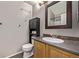 Cozy bathroom featuring single sink vanity and a framed mirror at 6358 E 121St Pl, Brighton, CO 80602