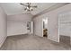 This carpeted bedroom includes open doorway to bathroom and attached closet at 6358 E 121St Pl, Brighton, CO 80602