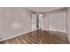 A well-lit bedroom with wood floor, closet, and neutral colored paint at 6358 E 121St Pl, Brighton, CO 80602
