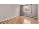 Bedroom with wood floors featuring a window with curtains and neutral paint at 6358 E 121St Pl, Brighton, CO 80602
