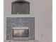 Living room fireplace with gray tile surround and hearth at 6358 E 121St Pl, Brighton, CO 80602