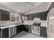 Kitchen with dark cabinets, stainless steel appliances, and natural light at 6358 E 121St Pl, Brighton, CO 80602