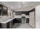 Well-lit kitchen with stainless steel appliances and dark cabinets at 6358 E 121St Pl, Brighton, CO 80602