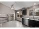 Kitchen and dining area with view of staircase and dark cabinets at 6358 E 121St Pl, Brighton, CO 80602