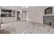 Open concept living room features wood flooring, fireplace, and access to stairs at 6358 E 121St Pl, Brighton, CO 80602