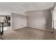 Spacious living room featuring neutral carpet, fresh paint, and ample natural light at 6358 E 121St Pl, Brighton, CO 80602